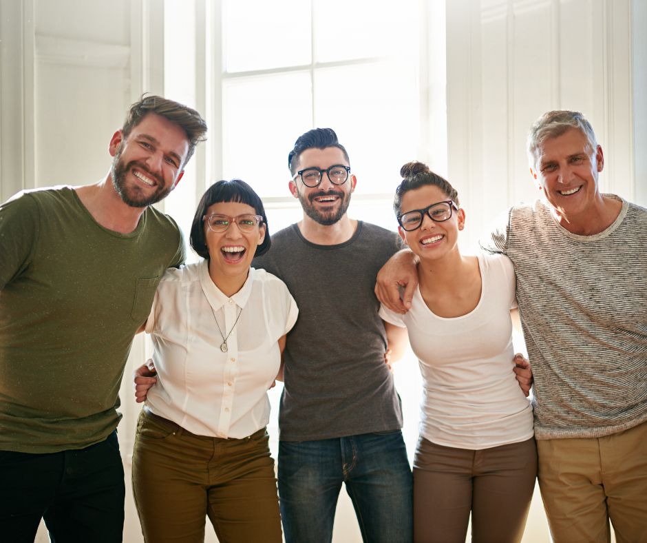 Coworkers smiling and embracing in a supportive workplace